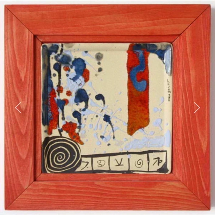 M09: a red-framed ceramic panel with red and blue marks, a black spiral and a row of signs.