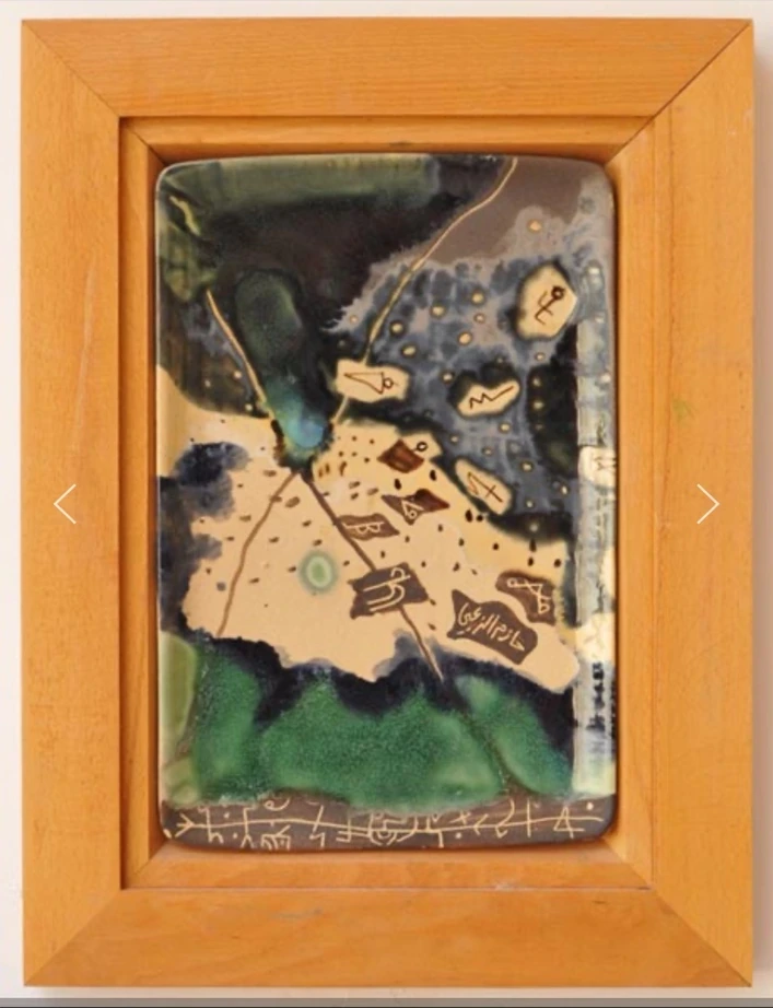 M10: a vertical ceramic panel in a wooden frame, with green glaze, dark fields and small inscribed shapes.