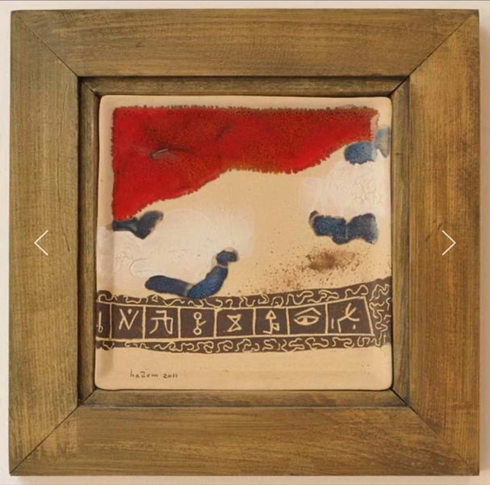 M11: a pale ceramic panel with a red upper band, blue marks and a row of dark symbols along the bottom.