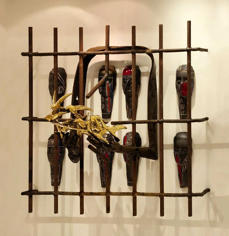Faces behind a metal grille; hands carry golden birds.