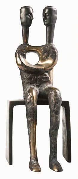 A seated two-headed figure with a circular opening in the torso.