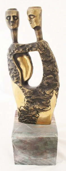 Two heads and an open torso on a stone base.