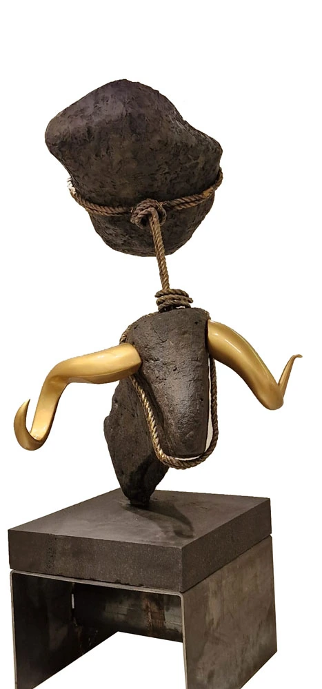 A stone composition bound with rope, with two metal horns.
