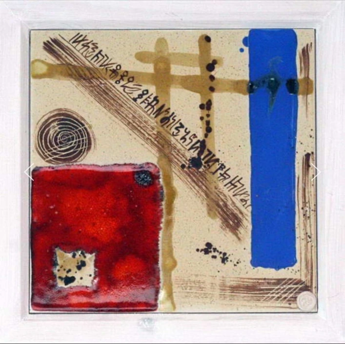 M19: ceramic panel with a red square, a blue vertical band, a spiral and diagonal lines of script.