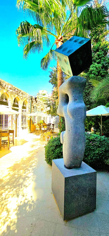 A stone form and die outdoors; a side view.