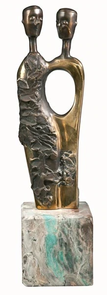 Two heads and an opening in the torso, on a green base.