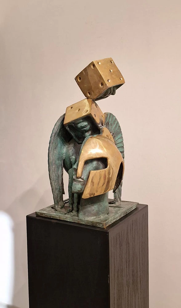 A helmeted head and golden dice; a three-quarter view.