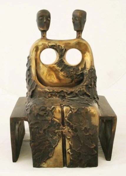 Two heads and two circular openings above a seated form.