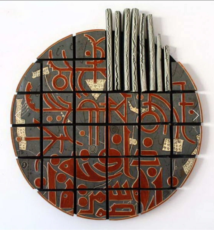 M42 · A circular tiled work with red signs and vertical elements.