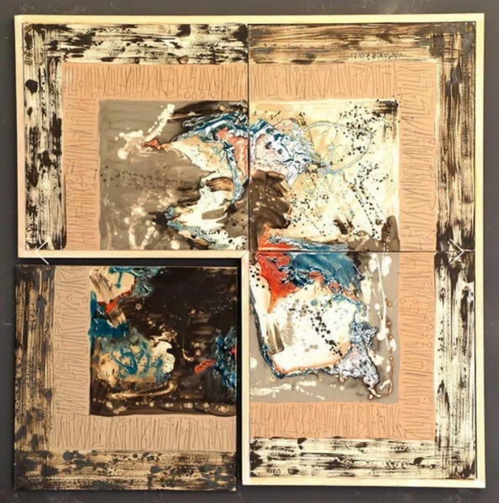 M31: four ceramic panels with pale pink borders and mottled blue, black, cream and rust-coloured surfaces.