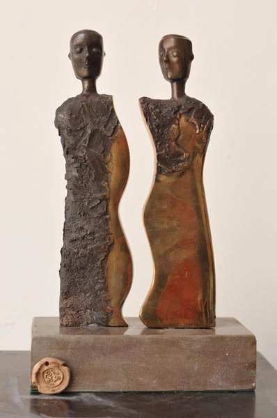 Two standing figures with contrasting smooth and textured surfaces.