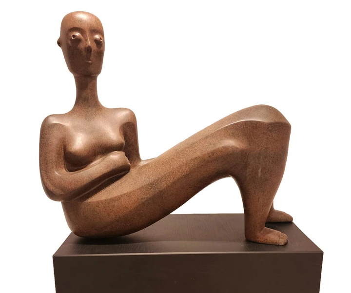 A reclining figure with bent knees, against a white background.