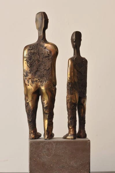 Two standing figures of different heights; rear view.
