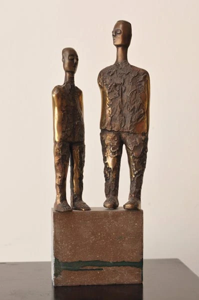 Two standing bronze figures on a shared base.