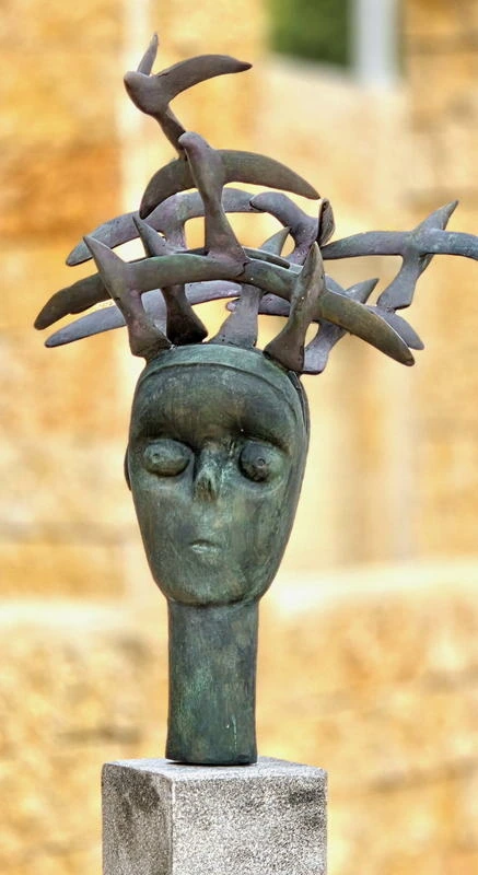 The crowned head from another angle, the ring of birds reading as a single band.