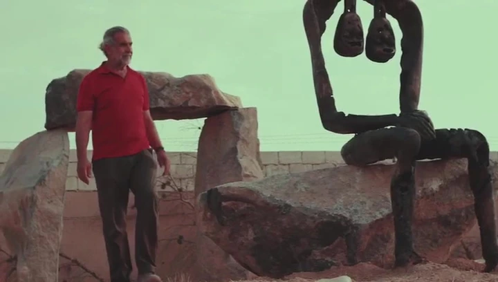 Installing a bronze and stone work outdoors. Amman. Fourteen seconds, silent.