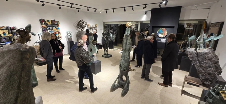Guests moving among the sculptures in the hall.