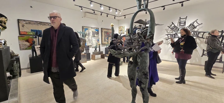 Guests and sculptures across the gallery hall.