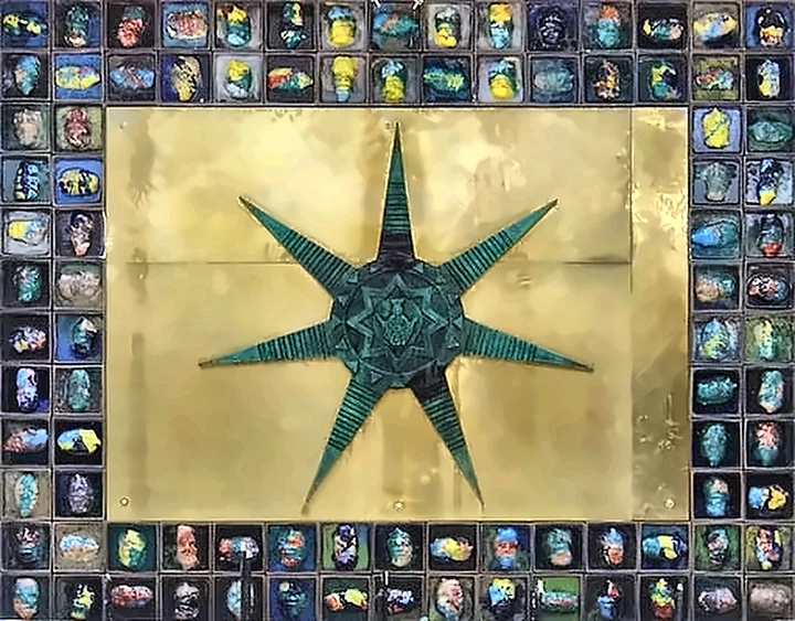 A large panel: a green eight-pointed star on a gold ground, bordered on all four sides by roughly a hundred small tiles, each a painted face in a different colour.