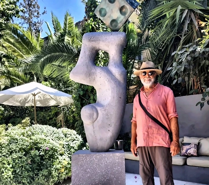 Carved stone with bronze cube, garden installation, 2024.