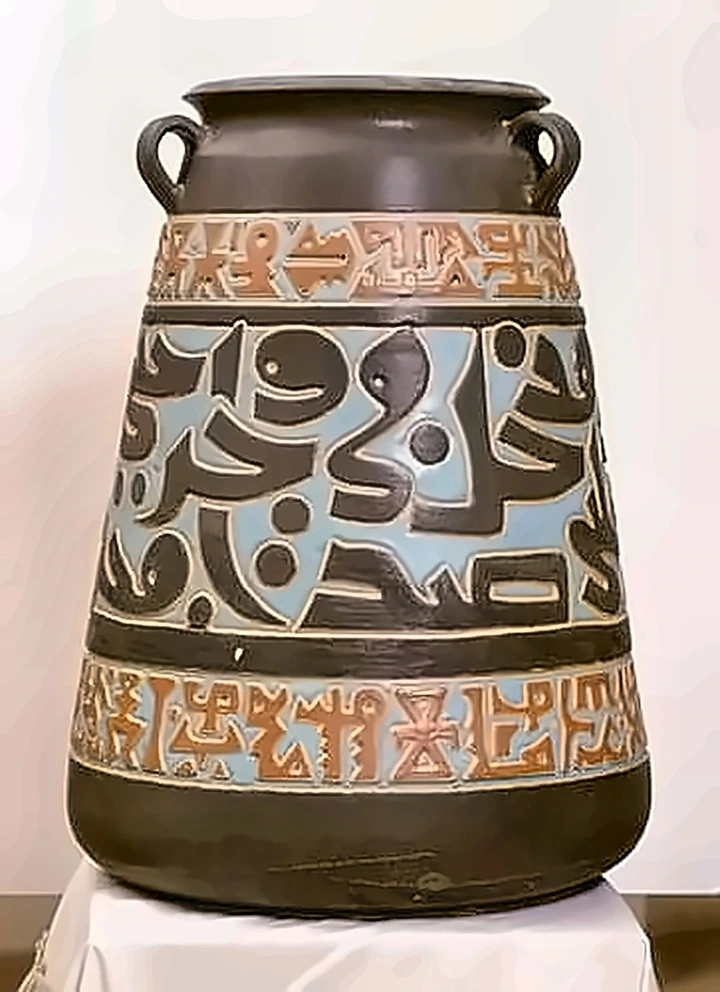 A large dark two-handled jar with three bands of incised script, the middle band pale blue, the outer bands terracotta.