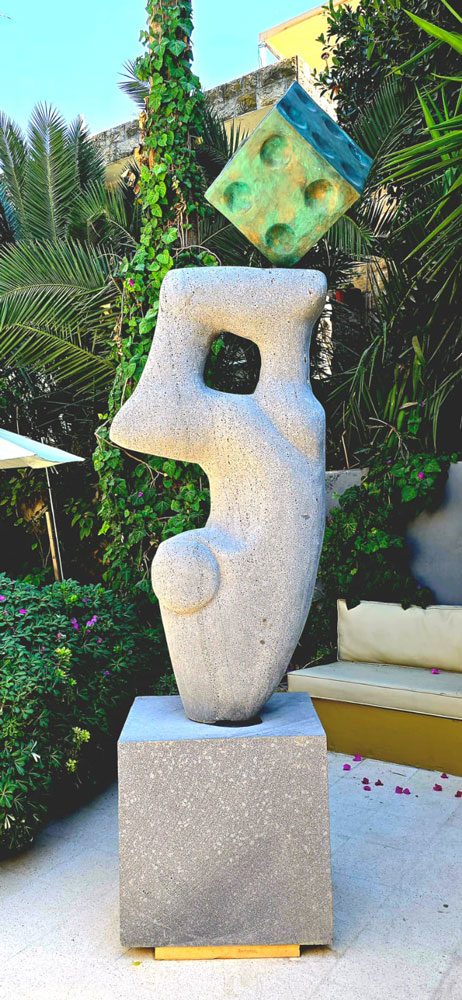 A stone form and die outdoors; a front view.